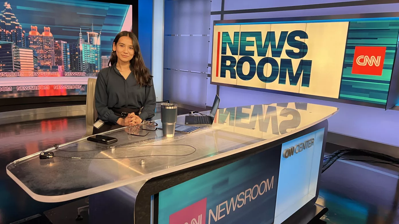 Oswego student Clarissa Karki sits at the CNN news desk at the CNN headquarters in Atlanta.