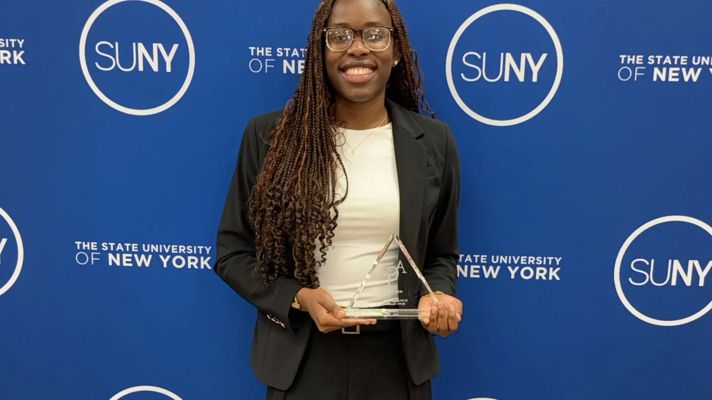 student holding her award smiling