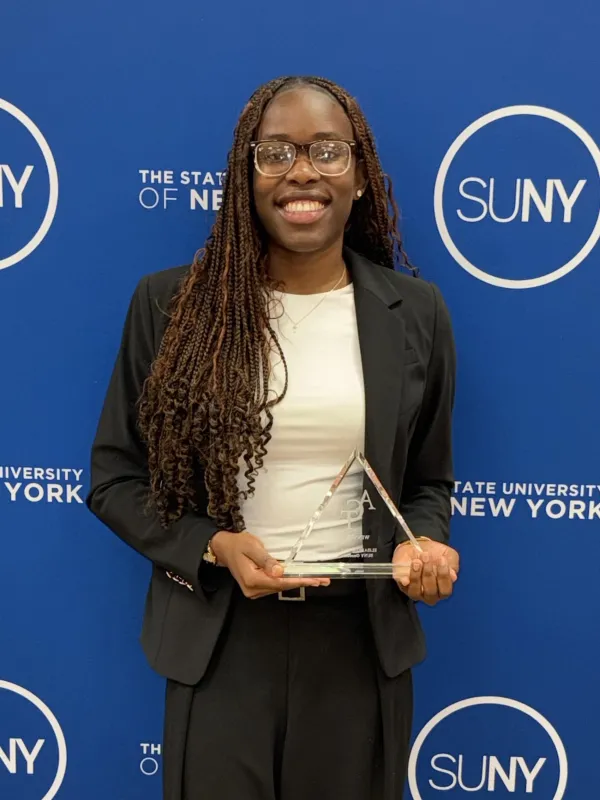 student holding her award smiling
